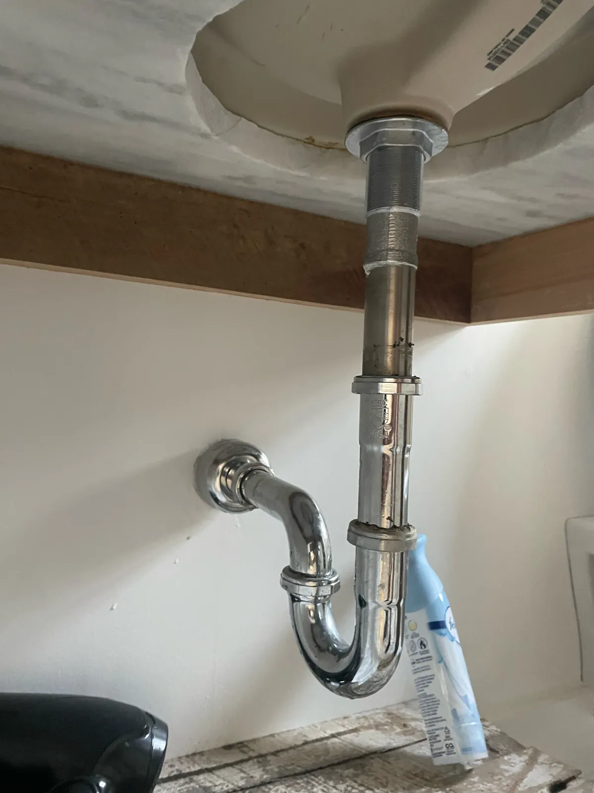 Chrome P-trap and drain connection beneath a bathroom sink