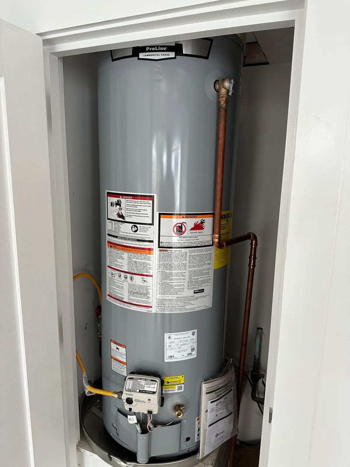 Installed tank water heater with connected gas and water lines
